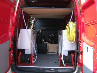 Van mounted pressure washer viewed from rear doors